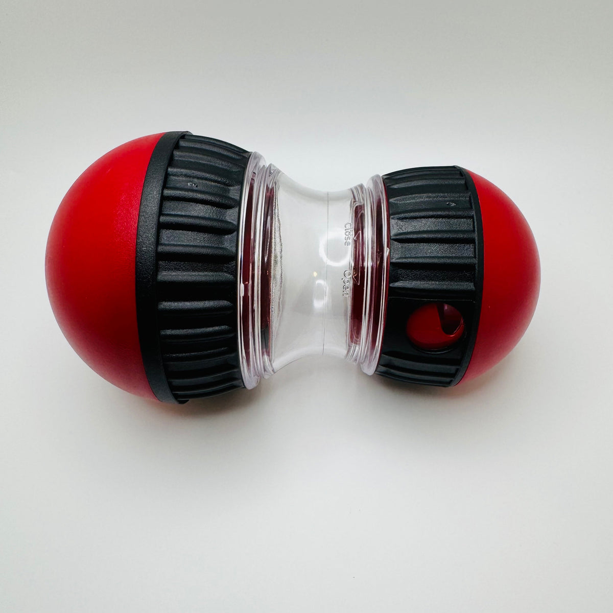 Oval slow feeder and treat dispenser toy for dogs and cats